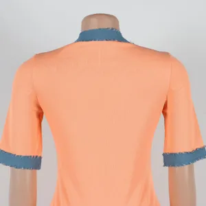Back detail of orange ribbed top with denim patch collar and cuffs. High stretch fabric.