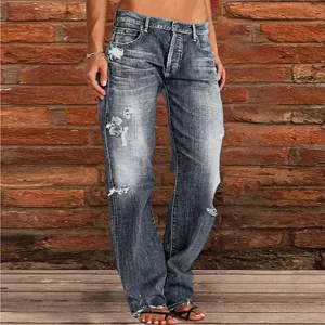 Close-up detail of women's washed distressed flare jeans featuring stylish ripped design.