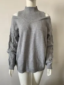 Grey cold shoulder turtleneck sweater detail, stylish knitwear showing unique cable sleeves.