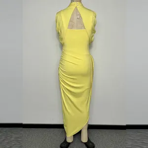 Detailed back view of the elegant yellow two-piece dress with cut-out and ruching design.