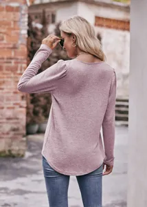 Back view detail of women solid color long sleeve puff sleeve casual top in soft pink fabric.