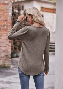 Detail view of the casual solid color long sleeve puff sleeve top featuring chic textured fabric.
