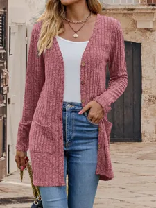 Close-up view of the pink knitted cardigan showing texture, V-neck, and front pockets.