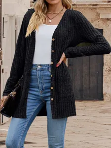 Close-up details of the black V-neck knitted cardigan with long sleeves and practical pockets.