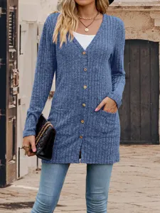 Detailed view of the stylish blue ribbed knit cardigan with button closure and pockets.