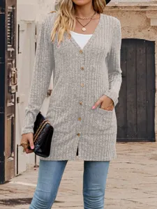 Detailed view of the stylish V-neck knitted cardigan featuring front pockets and chic buttons.