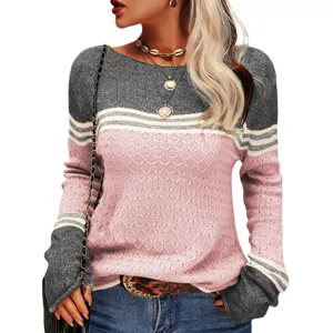 Close-up detail of the color-blocked textured knit sweater sleeve and striped pattern.