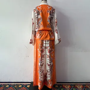 Detailed view of the stylish two-piece floral print outfit featuring a long-sleeve top and pants.