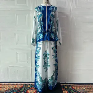 Detailed view of women two-piece outfit featuring blue white floral peacock print jacket and pants.