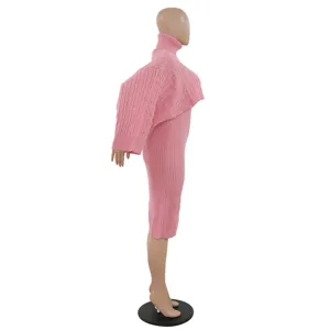 Detailed side view of a stylish pink turtleneck knit sweater and tank dress two-piece set.