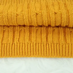 Yellow knitted sweater fabric detail texture macro shot close up soft cozy winter wear material