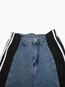 Denim pants waist detail showcasing high-waist design with contrast black side panel stripes.