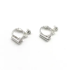 Close-up detail of silver screw-on earring converters for non-pierced ears, eco-friendly metal.