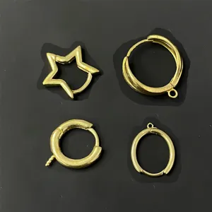 Close-up of golden DIY jewelry findings, including star and hoop earring components.