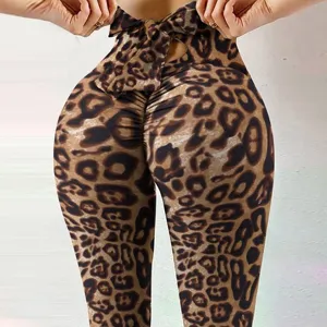 Leopard print high waist yoga pants with bow detail and scrunch peach hip design for fitness.