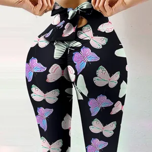 Close-up detail of women high waist peach hip yoga pants with cute bow and colorful butterfly print.