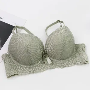 Close-up of the elegant light green lace push-up bra with delicate floral details and bow.