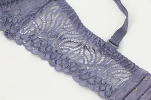 Detailed view of women purple lace bra strap back closure comfortable lingerie item.