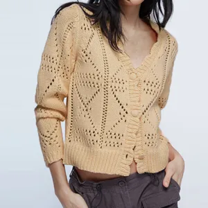 Detailed view of the women's yellow V-neck knit cardigan sweater featuring hollow-out patterns.