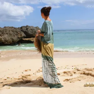 Beach scene detail showing gradient tie-dye maxi cover-up dress in relaxed fit.