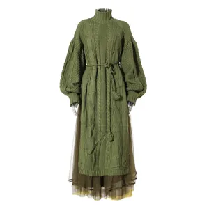Detailed close-up view of the olive green cable knit sweater dress with layered mesh skirt.