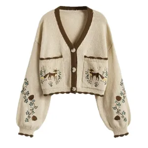 Joli gilet en tricot beige à col en V pour femmes avec broderie et finitions marron.