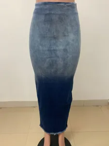 Detail shot of the gradient wash denim maxi skirt featuring a chic frayed raw hem.