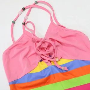 Close-up of colorful striped halter long dress front tie and beaded straps detail