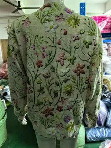Casual crewneck long sleeve knit sweater featuring intricate allover floral embroidery details.
