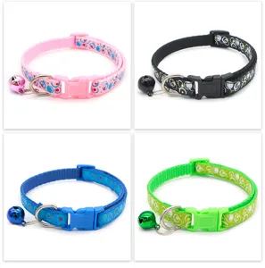 Detailed view of colorful bubble patterned pet collar with safety bell and adjustable buckle.