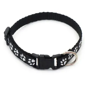 Details of black pet collar featuring white paw print, durable plastic buckle, and metal D-ring.