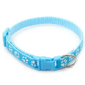 Close up detail of the blue pet collar featuring cute white paw print patterns and durable buckle.