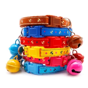Close-up view of adjustable fabric pet collar with anchor pattern and ringing bell for cats.