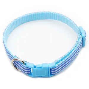 Close-up detail of blue and white plaid pet collar, featuring durable plastic buckle and ring.