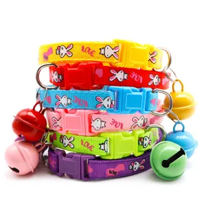 Detailed view of colorful pet collar with bell, adjustable strap and cute cartoon print.