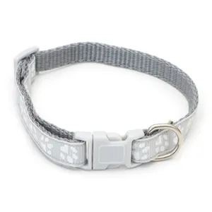 Close-up detail of gray pet collar featuring white paw prints, durable plastic buckle and metal ring.