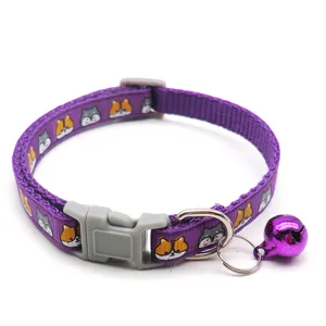 Close-up view of a purple woven pet collar with cute cartoon patterns, a bell and buckle.
