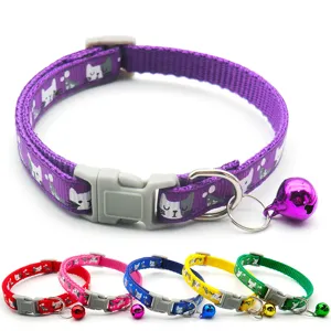 Close-up detail of adjustable pet cat collar with cute cat print, plastic buckle, and bell.
