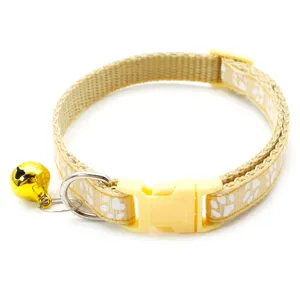 Adjustable yellow pet collar featuring white paw print design, buckle and cute bell.