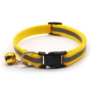Reflective pet collar detail with buckle and bell, adjustable safety strap for cats and dogs.