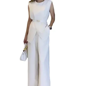 Detail view of stylish elegant white sleeveless top and matching wide-leg trousers two-piece outfit.