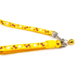 Yellow pet collar detail showing paw and bone print, 1cm width, metal hook, and cute bell.