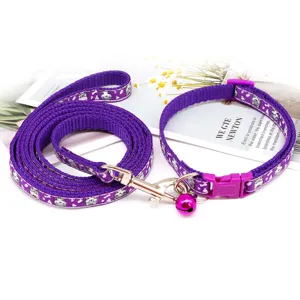 Purple pet leash and collar set detail view, featuring cute cartoon cat print and bell.