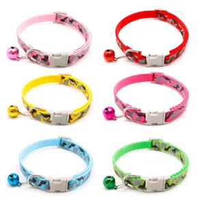 Adjustable camo pet collar detail showing metal d-ring, secure plastic buckle and cute bell.