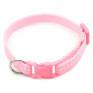 Pink plaid pet collar detail featuring secure plastic buckle and durable metal D-ring.