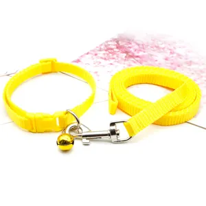 Yellow pet collar and leash set detail, adjustable nylon strap with metal buckle and cute bell.