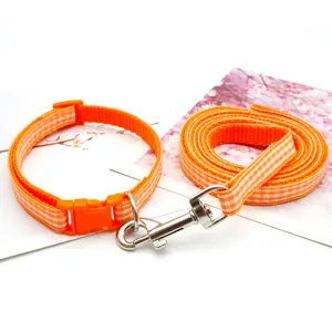Orange plaid pet collar and leash set, durable nylon outdoor dog walking supplies detail.