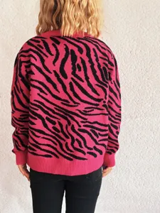 Stylish pink and black zebra print long sleeve knit sweater for women, casual and chic.