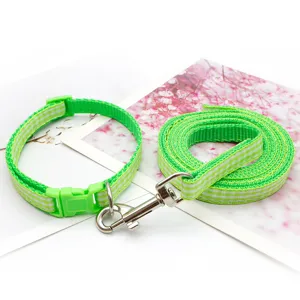 Green plaid pet collar and leash set detail shot, showing durable metal hooks and soft fabric.