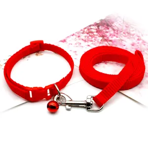 Red pet collar and leash set with bell, durable nylon webbing for small dogs and cats.